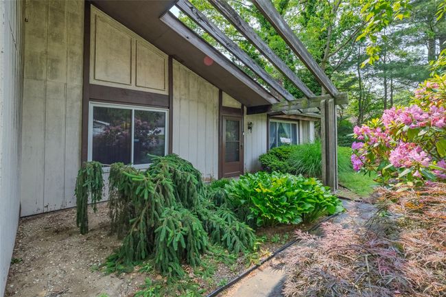 Doorway to outside with light colored carpet and baseboard heating | Image 6