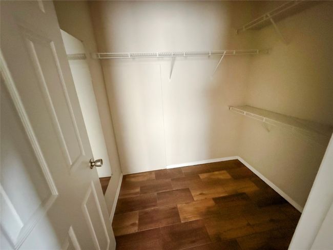 Walk in closet with wood finished floors | Image 17