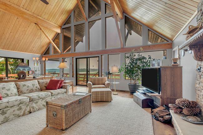 Welcome to this rustic A frame designed home , featuring spruce paneled vaulted ceilings , and views out every window. | Image 17