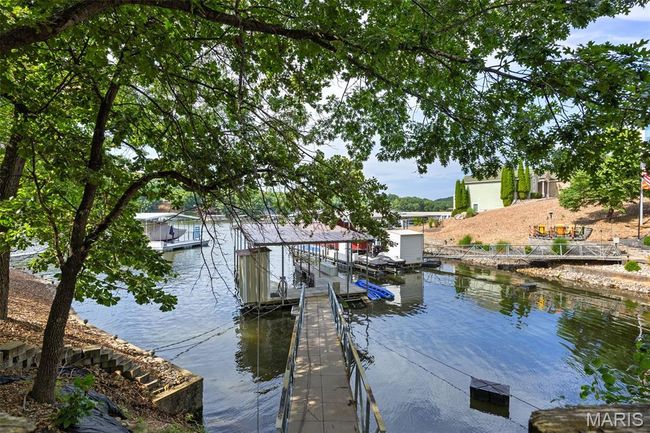 Dock area with a water view and boat lift | Image 32