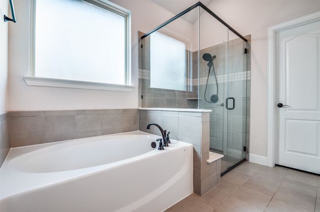Bathroom featuring a garden tub, a shower stall, and tile patterned flooring | Image 21