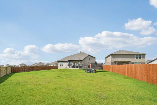 Fenced backyard with a trampoline | Image 30