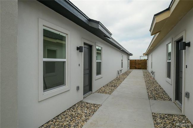 View of side of home with stucco siding and fence | Image 28