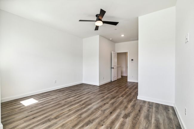 Unfurnished room featuring dark wood-style floors, baseboards, recessed lighting, and a ceiling fan | Image 19