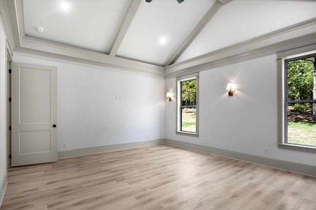 Spare room featuring light wood-style flooring and ceiling fan | Image 18