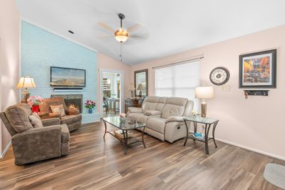 Living room/family room with wood burning fireplace. | Image 3