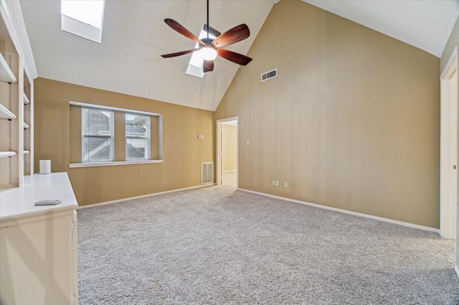 Upstairs is the 16’x14 den with vaulted ceiling and skylights. | Image 24