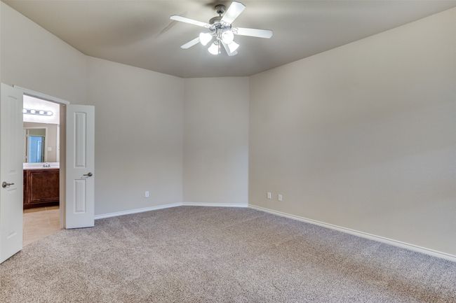 Bedroom featuring light carpet, baseboards, and ceiling fan | Image 17