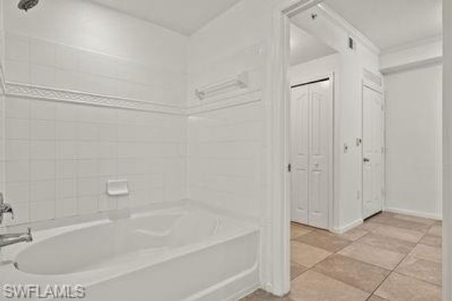 Bathroom featuring baseboards and tile patterned flooring | Image 25