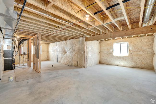 Below grade area with electric panel and water heater | Image 7