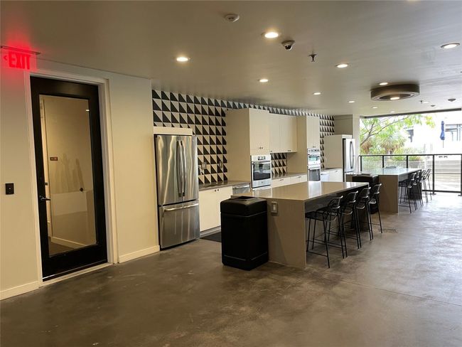 Kitchen with a breakfast bar area, recessed lighting, a kitchen island, and stainless steel appliances | Image 21