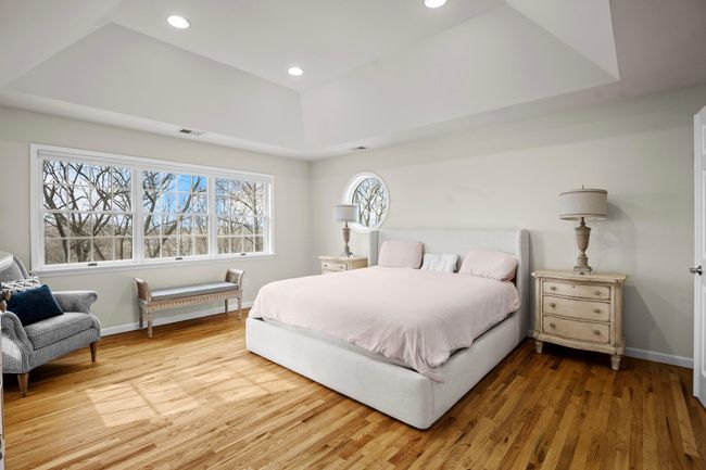 This inviting retreat offers warm hardwood floors, beautiful symmetry, and plenty of room to relax and recharge in luxurious comfort. | Image 22