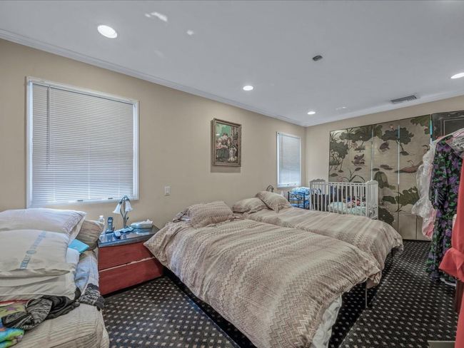 Bedroom with carpet floors, crown molding, and recessed lighting | Image 24