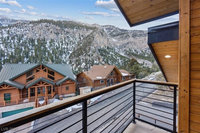 Snow covered back of property with a mountain view | Image 24