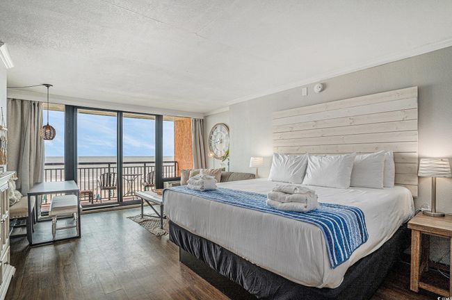 Bedroom with access to exterior, dark wood-style flooring, crown molding, and a textured ceiling | Image 5