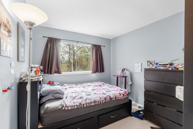 Carpeted bedroom with a textured ceiling and baseboards | Image 15