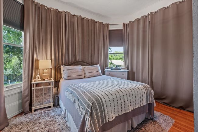 Bedroom featuring multiple windows and wood finished floors | Image 24