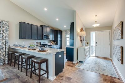 Open kitchen with excellent lighting and quality finishes. Photo of Model Home. Options and colors may vary. Ask Sales Agent for details. | Image 1