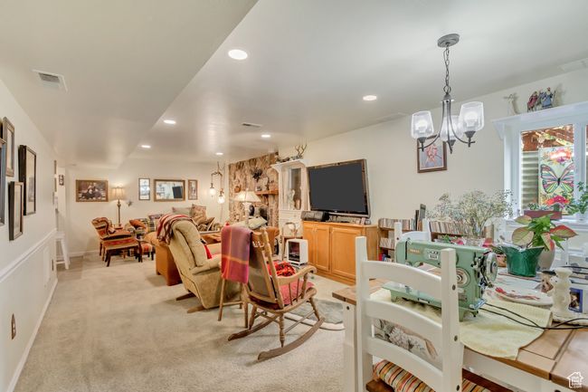Living room with light carpet, visible vents, an inviting chandelier, and recessed lighting | Image 36