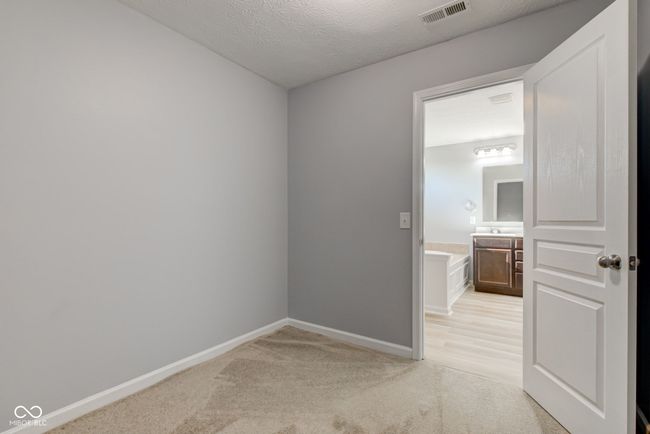 empty room featuring light colored carpet and a textured ceiling | Image 37
