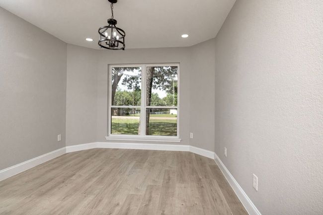 Unfurnished room with light wood-type flooring, a chandelier, and recessed lighting | Image 25