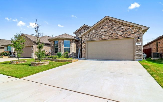 View of front of property featuring brick siding, a front lawn, an attached garage, and concrete driveway | Image 17