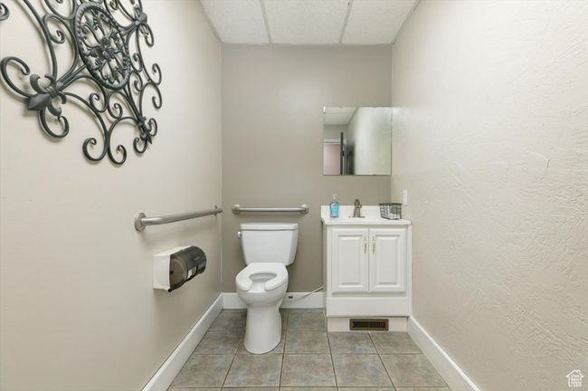 Bathroom with vanity, a drop ceiling, and tile patterned floors | Image 6