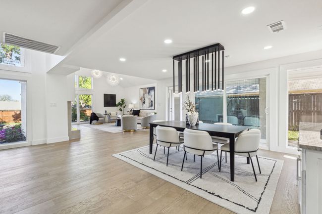 Dining space with plenty of natural light, visible vents, and light wood finished floors | Image 12