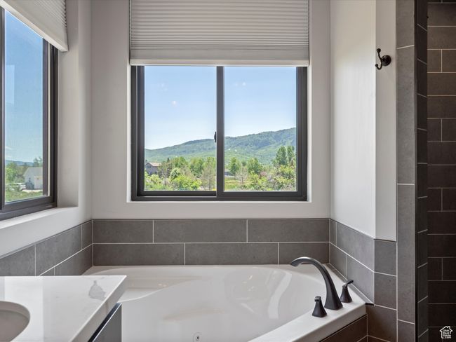 Full bath featuring plenty of natural light, a tub with jets, and vanity | Image 29