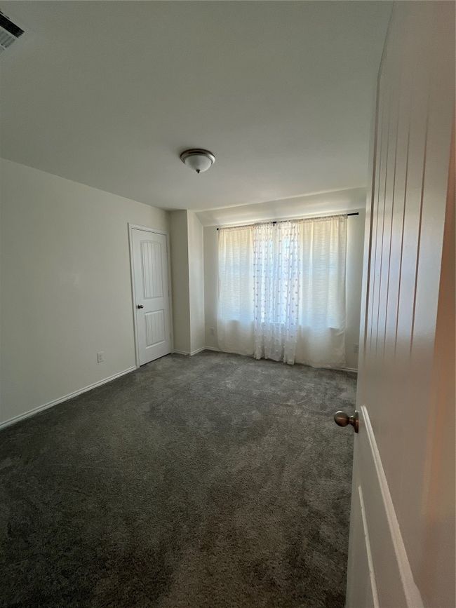 Carpeted spare room with baseboards and visible vents | Image 21