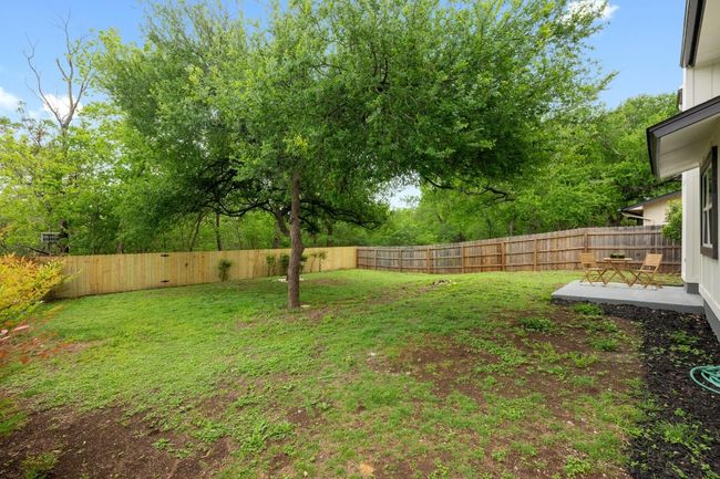 View of yard featuring a fenced backyard and a patio area | Image 25