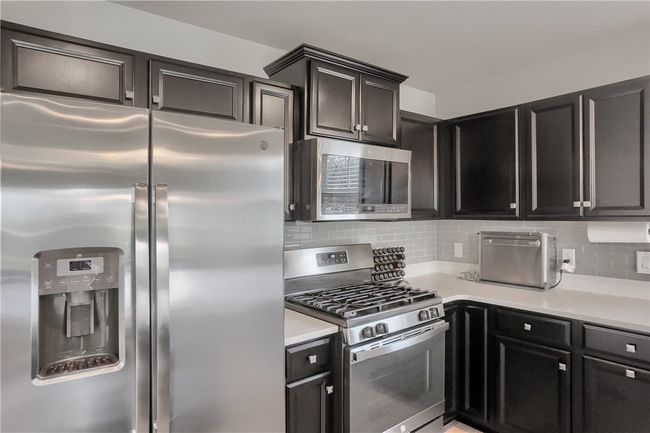 Stainless appliances round out this modern space. | Image 31