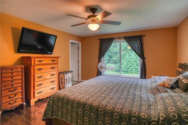Bedroom with dark wood-type flooring and ceiling fan | Image 23