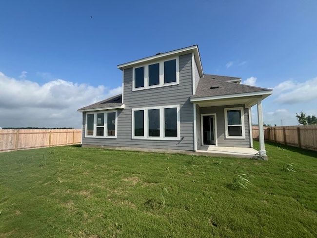 Back of house featuring a fenced backyard, a shingled roof, and a patio area | Image 10
