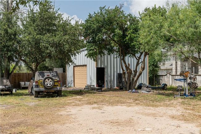 View of front of house with a garage and an outdoor structure | Image 9