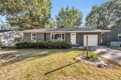 Ranch-style home featuring a garage and a front lawn | Image 1