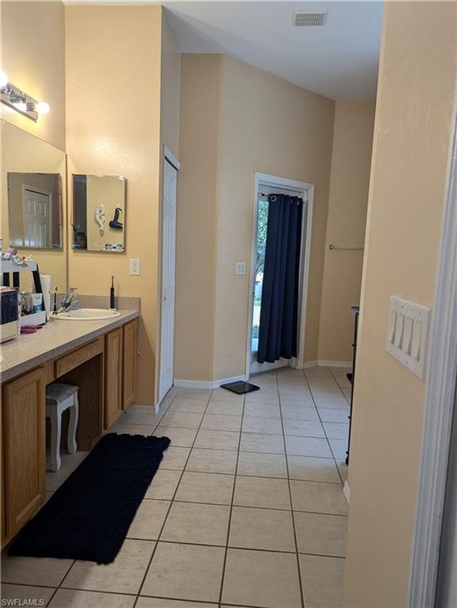 Bathroom featuring tile patterned floors, vanity, and baseboards | Image 10