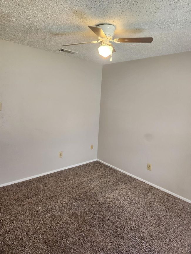 Spare room with ceiling fan, carpet, a textured ceiling, and baseboards | Image 15