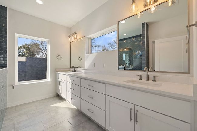 Primary Bathroom with recessed lighting, a sink, a tile shower, and double vanity | Image 27