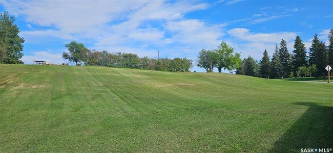 View of community featuring view of golf course and a lawn | Image 19