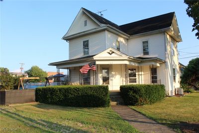 Street view of front of home featuring central AC and a front yard | Image 2