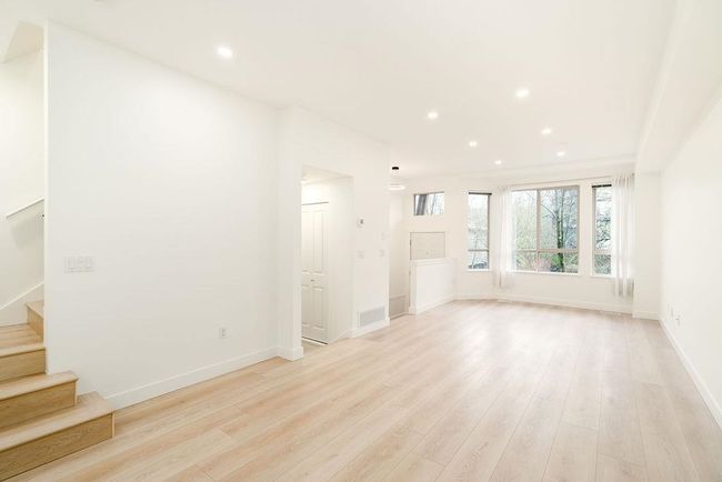 Unfurnished living room featuring stairway, recessed lighting, baseboards, light wood-style floors, and visible vents | Image 18