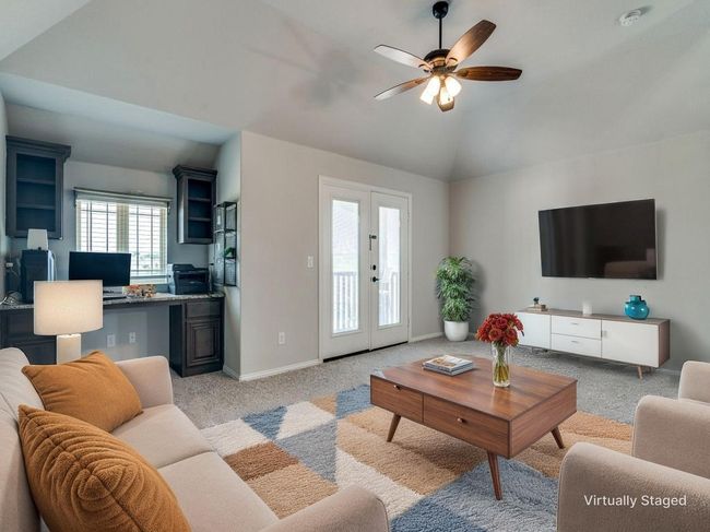 Living room featuring light carpet, ceiling fan, vaulted ceiling, french doors, and baseboards | Image 40