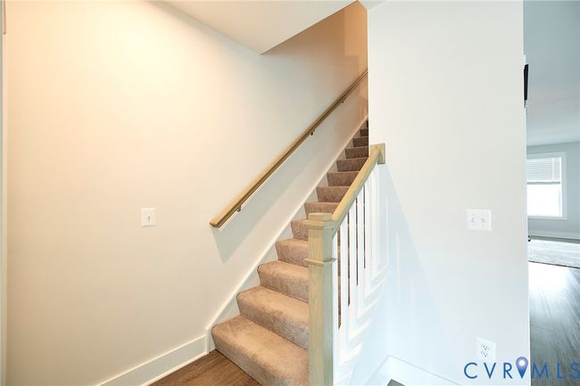 Stairway with baseboards and wood finished floors | Image 26