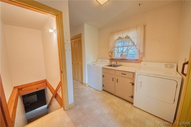 Laundry area featuring washer / clothes dryer, sink, and cabinets | Image 27