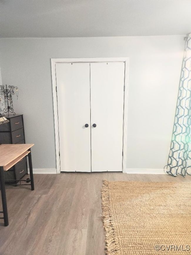 Bedroom featuring wood finished floors and a closet | Image 19