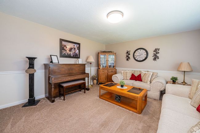 Living room featuring baseboards and carpet | Image 13