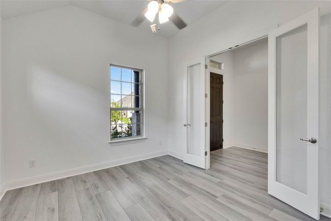 Spare room with ceiling fan, light wood-type flooring, and lofted ceiling | Image 4