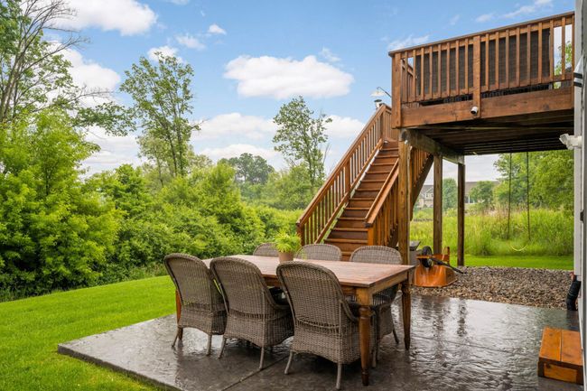 Deck has stairs down to the stamped concrete patio.. | Image 43