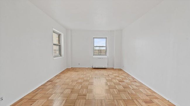 Spare room featuring radiator heating unit and baseboards | Image 9